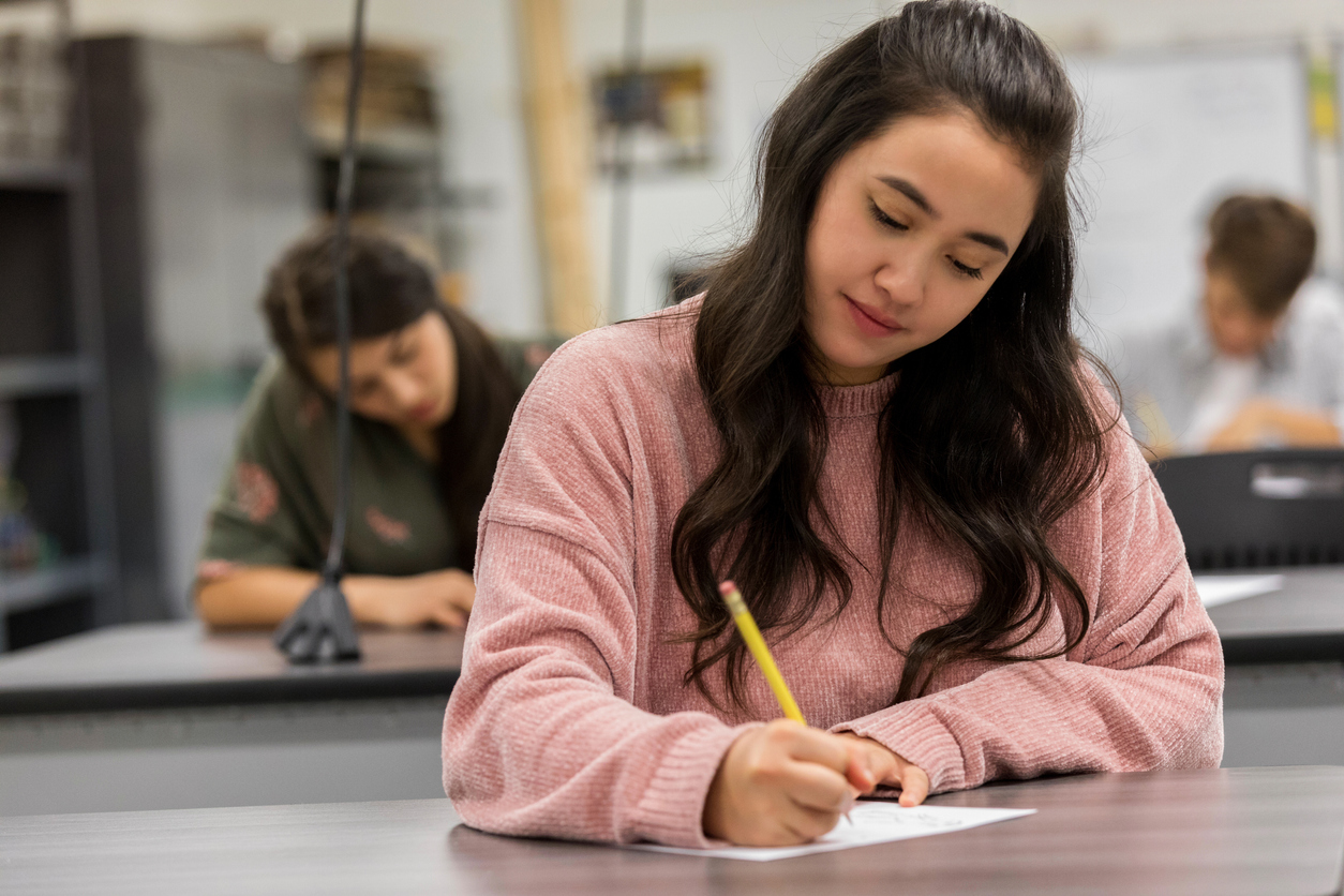 student holding pen